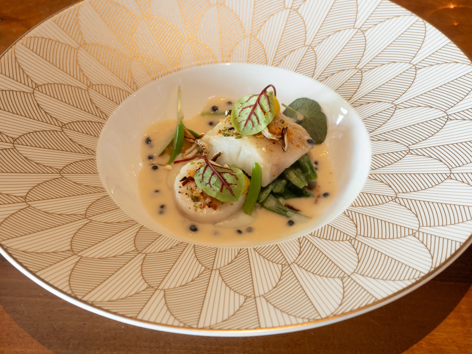 Fish dish plated in a patterned bowl