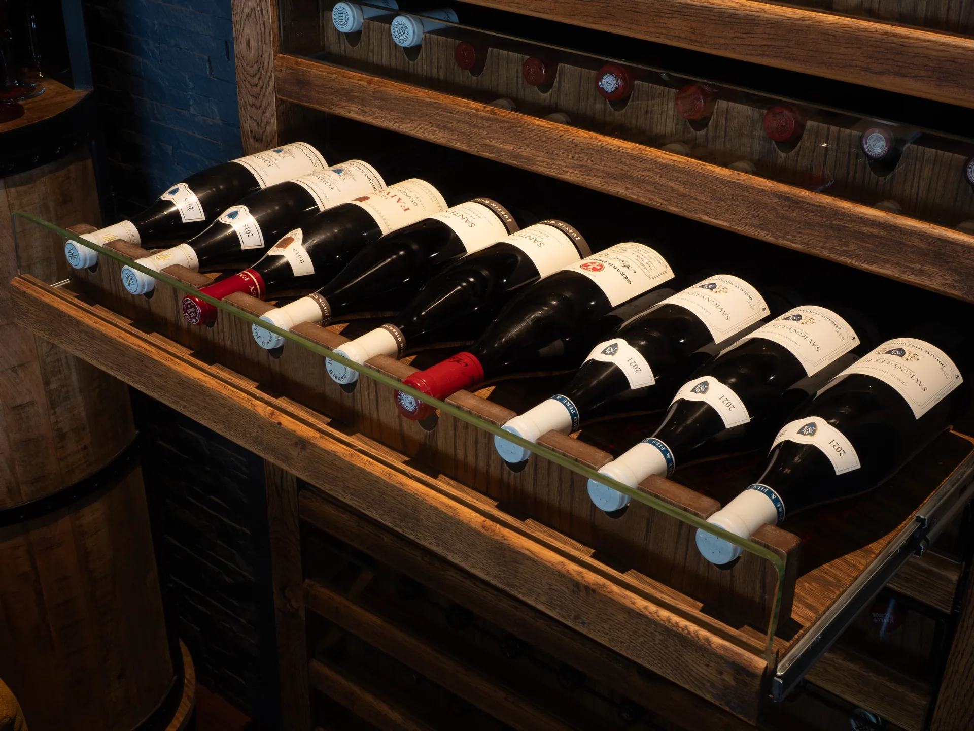 Wine bottles arranged in a wooden drawer